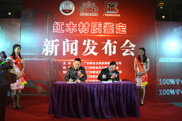 新會古典家具城有限公司董事長袁秋耘（左）與廣西大學林學院教授、享受國務院政府特殊津貼專家、國內最著名的木材鑒定專家徐峰教授（右）簽署文件引進無損快速檢測技術