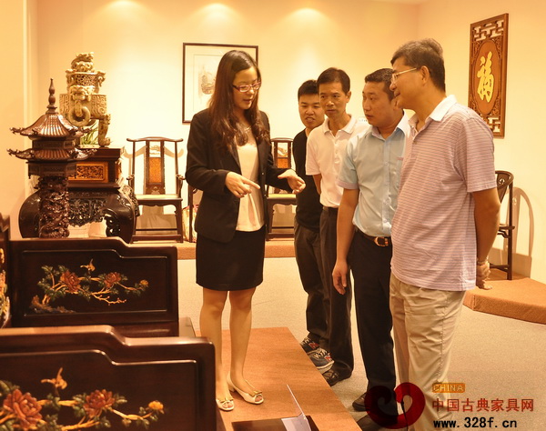 區(qū)氏臻品工作人員為參觀者詳細(xì)講解展出的小葉紫檀家具