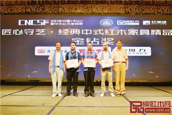 全聯(lián)藝術(shù)紅木家具專業(yè)委員會(huì)專家顧問—原故宮博物院文保科技部主任曹靜樓（右一）、亞太地區(qū)手工藝大師馮文土（左一）為“匠心守藝·經(jīng)典中式紅木家具精品獎(jiǎng)”金鉆獎(jiǎng)獲獎(jiǎng)企業(yè)頒獎(jiǎng)