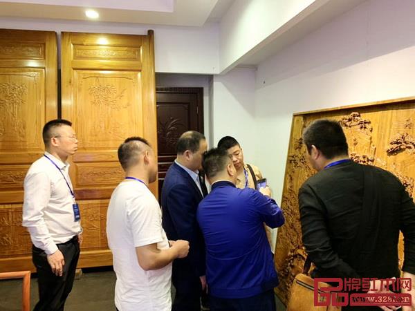 經(jīng)銷(xiāo)商們?cè)诠ぷ魅藛T陪同下參觀雅典紅木展廳，挑選心儀產(chǎn)品