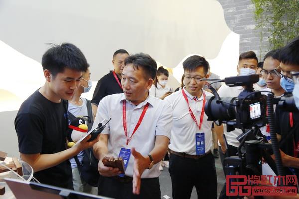 “中式原木整裝城市合伙人直播招募會(huì)”第一站在國方家居的建博會(huì)展位舉行,國方家居董事長陳新平(左二)介紹榫卯文化 “中式原木整裝城市合伙人直播招募會(huì)”第一站在國方家居的建博會(huì)展位舉行,國方家居董事長陳新平(左二)介紹榫卯文化